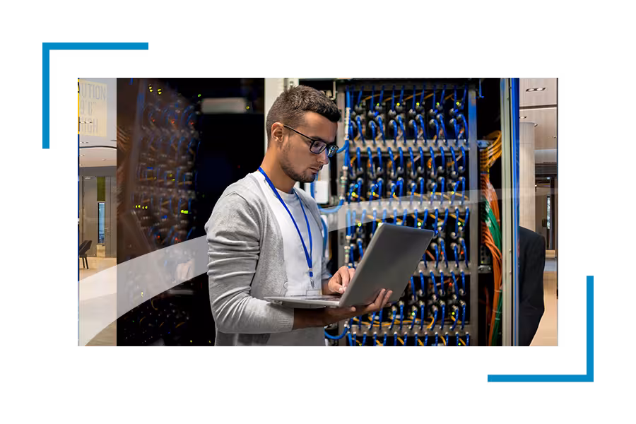 Man in a data center looking at the laptop