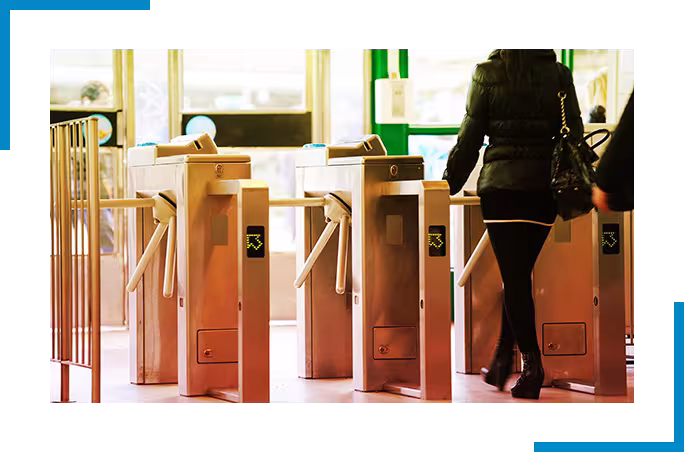 Woman walking through turnstile 